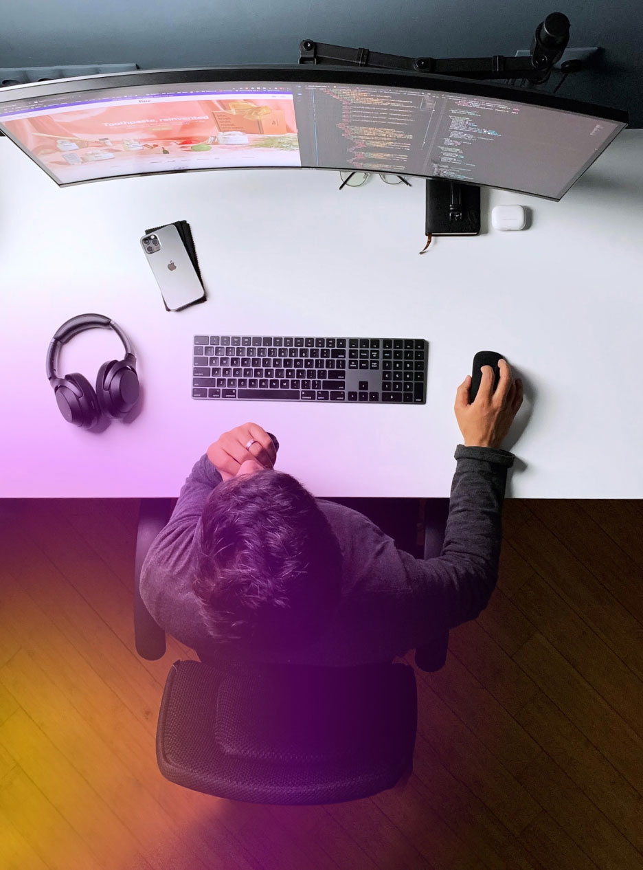 info-14 "Top view of developer working modern desk setup with curved monitor displaying code UI design, by tech gadgets. "